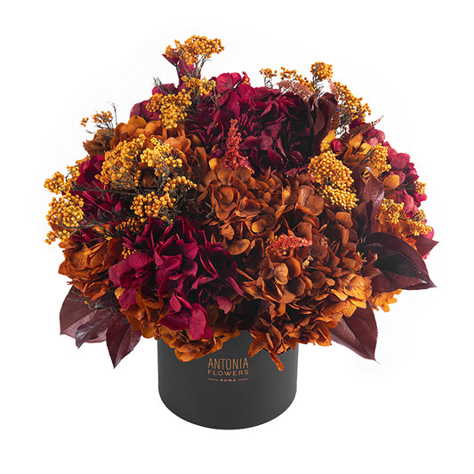 Composizione Florever Amber Sunrise con ortensie e fiori stabilizzati nei toni bordeaux, ambra e arancio