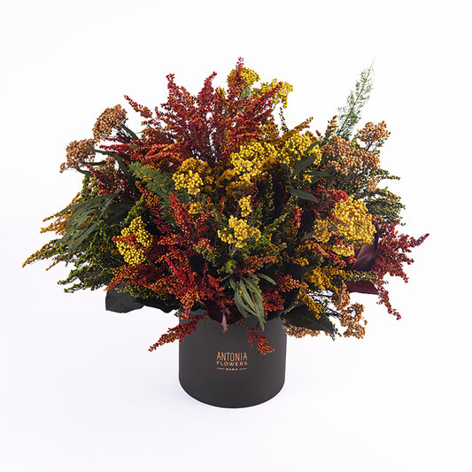 Composizione Florever Garden Party con fiori stabilizzati nei toni rosso, arancio, giallo e verde
